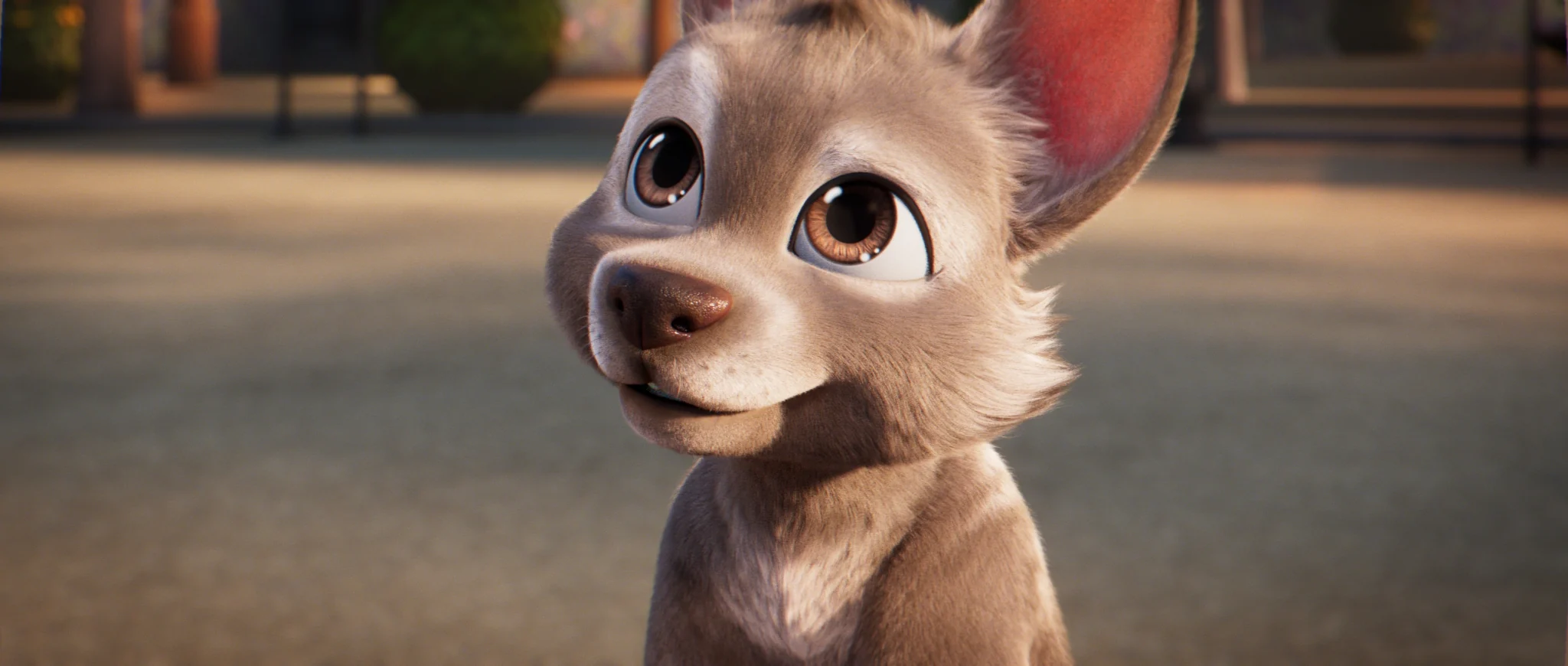 Close-up of a big-eared puppy looking up with shining eyes.